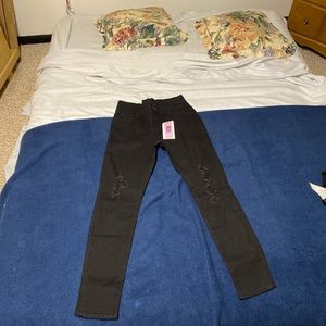 Never worn Charlotte Russe black ripped high rise jeans size. Tag still on